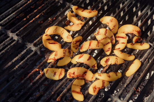 Sliced peaches on a grill