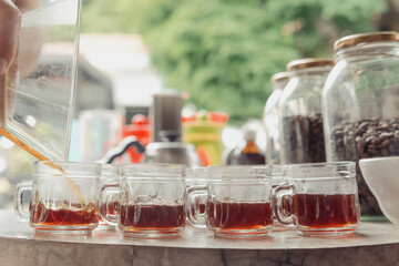 Small coffee tasting mugs filled with fresh brewed coffee