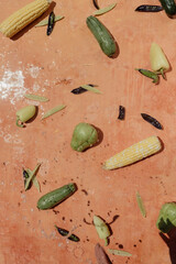 Vegetables and peppers on a pink background