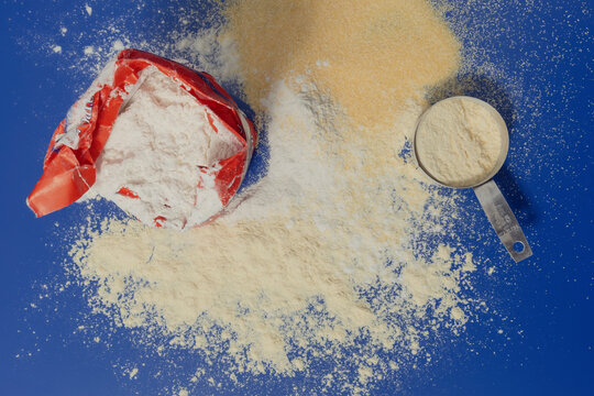 Assortment of flours and cornmeal on a blue background