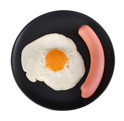 Fried egg and sausage on a black plate on a white background