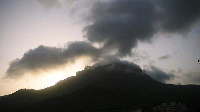 Beautiful view of clouds and fog on top of Girnar mountain during sunrise