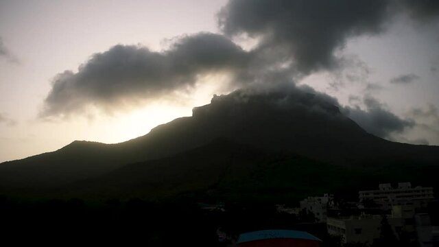 Beautiful view of clouds and fog on top of Girnar mountain during sunrise