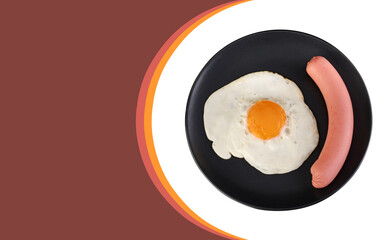 Fried egg and sausage on a black plate, on a white background, space for the text on a dark red background