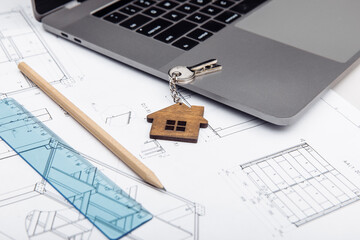 Architectural plan, laptop and house key