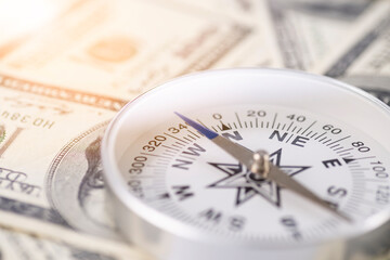 Travel compass on the background of American dollars