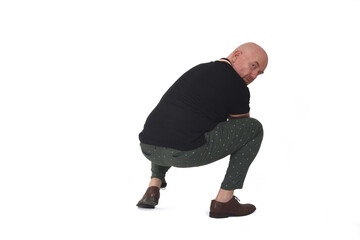 Naklejka premium rear view of a man looking at camera and sitting squatting on white background