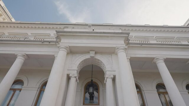 Facade of Livadia Palace in Crimea. Action. Beautiful facade of white old building with columns in European style. Tourist former palace in Crimea