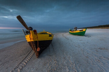 A fishing wooden boat moored by the beach, Debki, Poland.