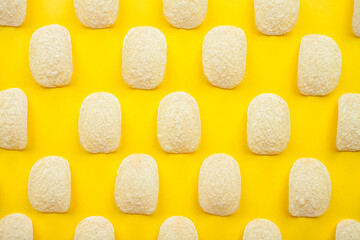 Chips pattern on a bright yellow background. Weight loss and diet concept. High quality photo