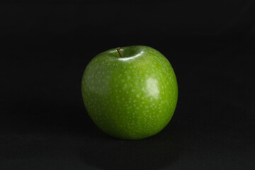green apple on black background