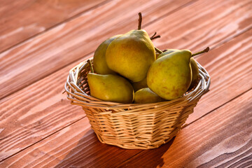Healthy Organic Pears in the Basket on wooden rustic background. Fresh pears from the farm. Healthy food full of vitamins