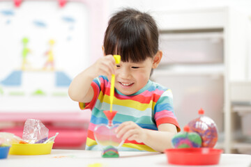 young girl making sand  crafts for homeschooling
