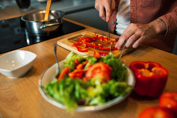 Cutting fresh vegetables in kitchen
