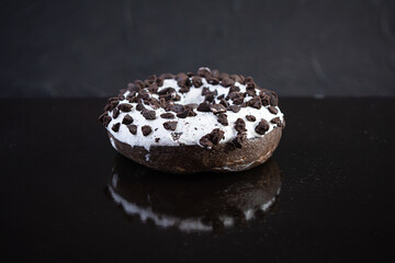 Single doughnut on dark background. Delicious doughnut with chocolate