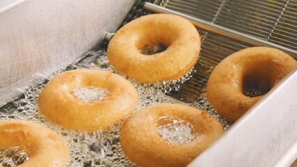 donuts being extracted from frier