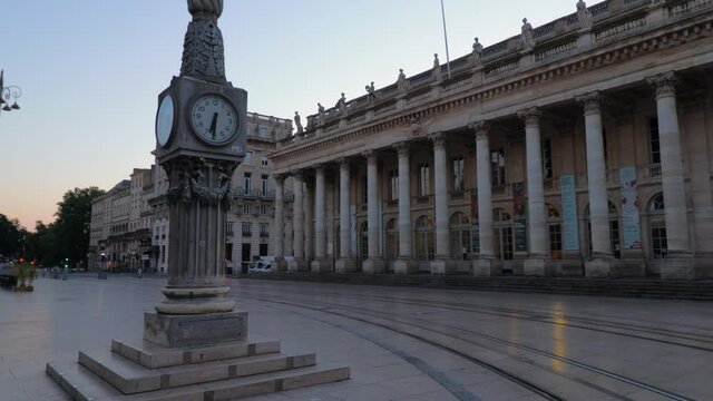 Tall clock and opera house in bordeaux during sunrise with nobody wide arc