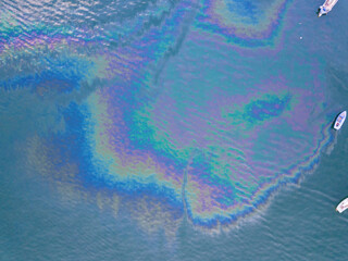 Oil or gasoline stains on the sea surface, directly above top view