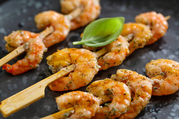 Shrimp skewers on dark plate