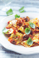 Ravioli with mushrooms and fresh basil. Close up.	