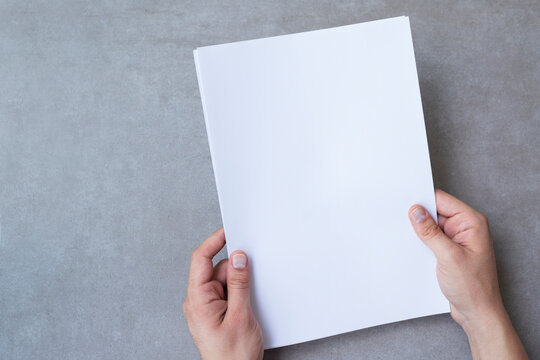 Male hands holding blank white paper
