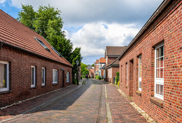 Cityscape of Dornum, East frisian, Germany. Narrow Street in city of Dornum