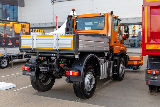 Utility truck Mercedes-Benz Unimog U423 with rotatry brush for cleaning roads, rear view. Construction Industry Fair Bauma CCT Russia. Moscow, Russia - May 25-28, 2021