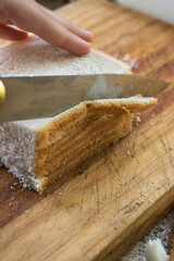 Cutting bread on a wooden board 