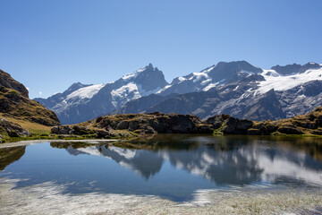 Reflection of the Mountain La Meije on the Lac Lérié in the French Alps 