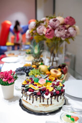 Festive cake with chocolate and fruits. Black forest cake. High quality photo.