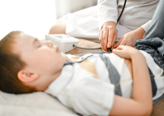 The child is a patient and a doctor. Measurement of blood pressure with a tonometer.