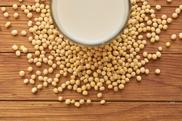 Take soy milk overhead, soybeans around glass of soy milk. Vegan food concept.