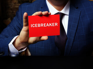 Business concept meaning ICEBREAKER with phrase on the sheet. An activity or game designed to welcome attendees and warm up the conversation among participants in a meeting - obrazy, fototapety, plakaty