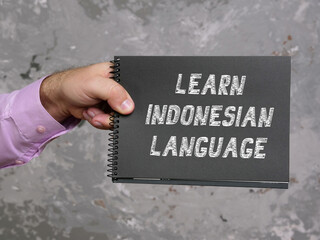 Financial concept about LEARN INDONESIAN LANGUAGE with phrase on the page.