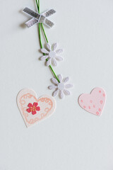 dainty paper flowers with paper hearts on a light background