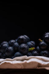 large grapes on a cloth on a black background.
A variety called Nagano Purple