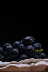 large grapes on a cloth on a black background.
A variety called Nagano Purple