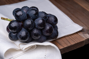 large grapes on a cloth on a black background.
A variety called Nagano Purple