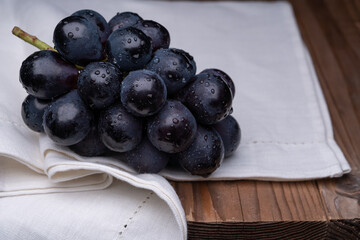large grapes on a cloth on a black background.
A variety called Nagano Purple