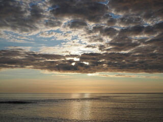 sunrise with clouds over atlantic ocean