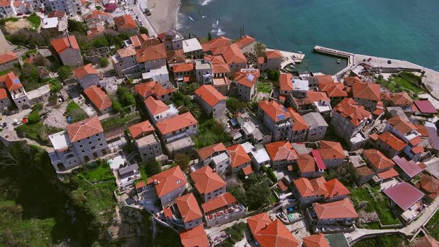 Picturesque panoramic view from the height of old European city of Ulcinj in Montenegro, and the beautiful turquoise bay off coast of the Adriatic Sea, drone shooting.