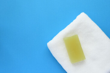 Towel and Soap on blue background.