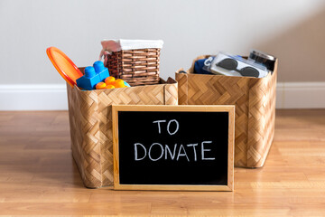 A woman prepared a box of things for a donation. Decluttering, cleaning and moderate consumption...