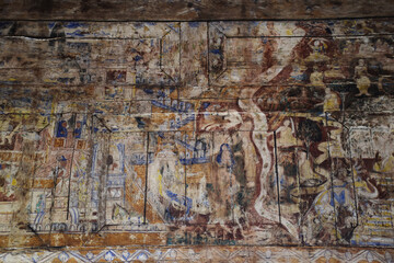 Paintings on the wooden walls in Thai temple
