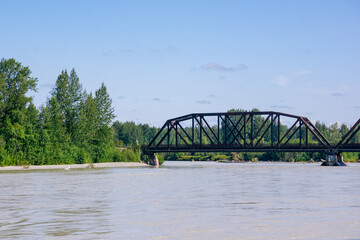 Bridge crossing Talkeetna River on warm summer day in Alaska.