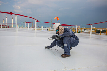 Male worker are for inspection  ultrasonic thickness roof plate top