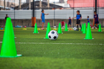 Obraz premium Soccer ball tactics cone on grass field with for training background