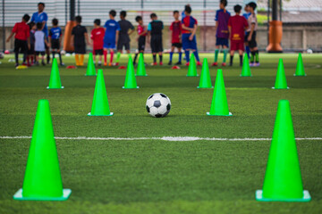 Soccer ball tactics cone on grass field with for training background