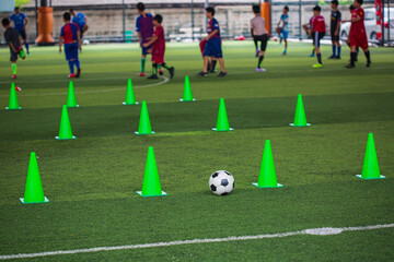 Soccer ball tactics cone on grass field with for training background