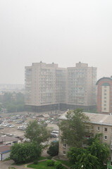 view of a multi-storey residential building in the haze of forest fires